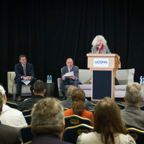 Presenter speaking at podium.